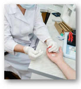 Photo of a medical professional taking blood from a patient's finger.