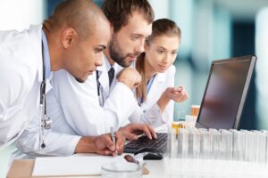 Team in a laboratory looking together at a computer screen