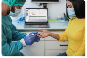 Photo of a medical professional performing a finger prick on a patient.