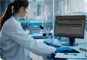 Photo of a lab technician working on a computer