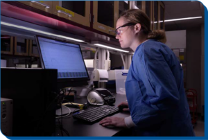 Photo of a laboratory technician using a computer.