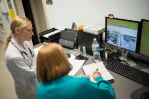 Photo of NC State Veterinary Medicine staff members looking at computer