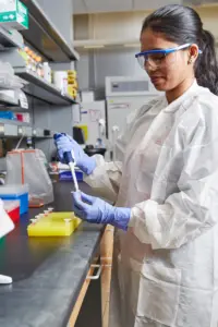 Photo of lab technician holding a pipette