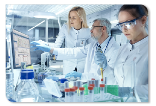 Scientists working with test tubes and pipettes looking at a computer monitor